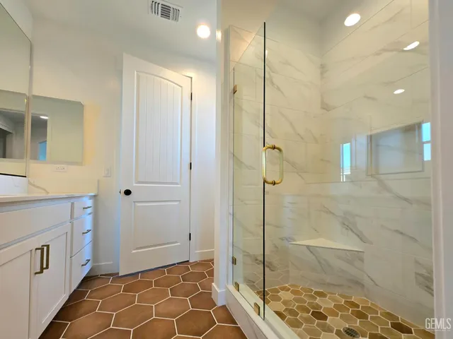 a bathroom with a glass door shower