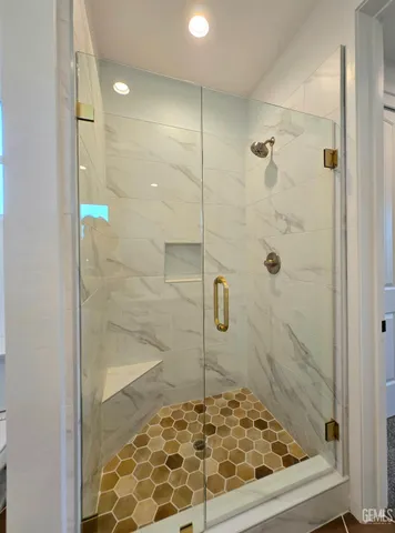 a bathroom with a glass shower door