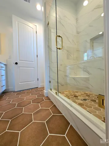 a bathroom with a glass door shower