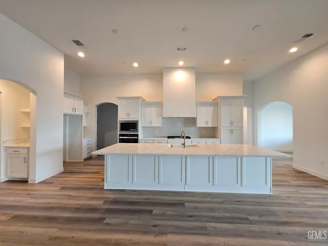 a kitchen with kitchen island cabinets and wooden floor