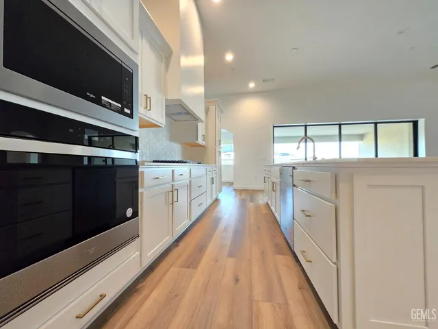 a view of a kitchen with a sink and wooden floor