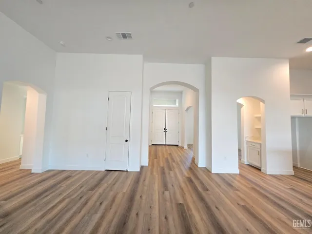 a view of a room with wooden floor