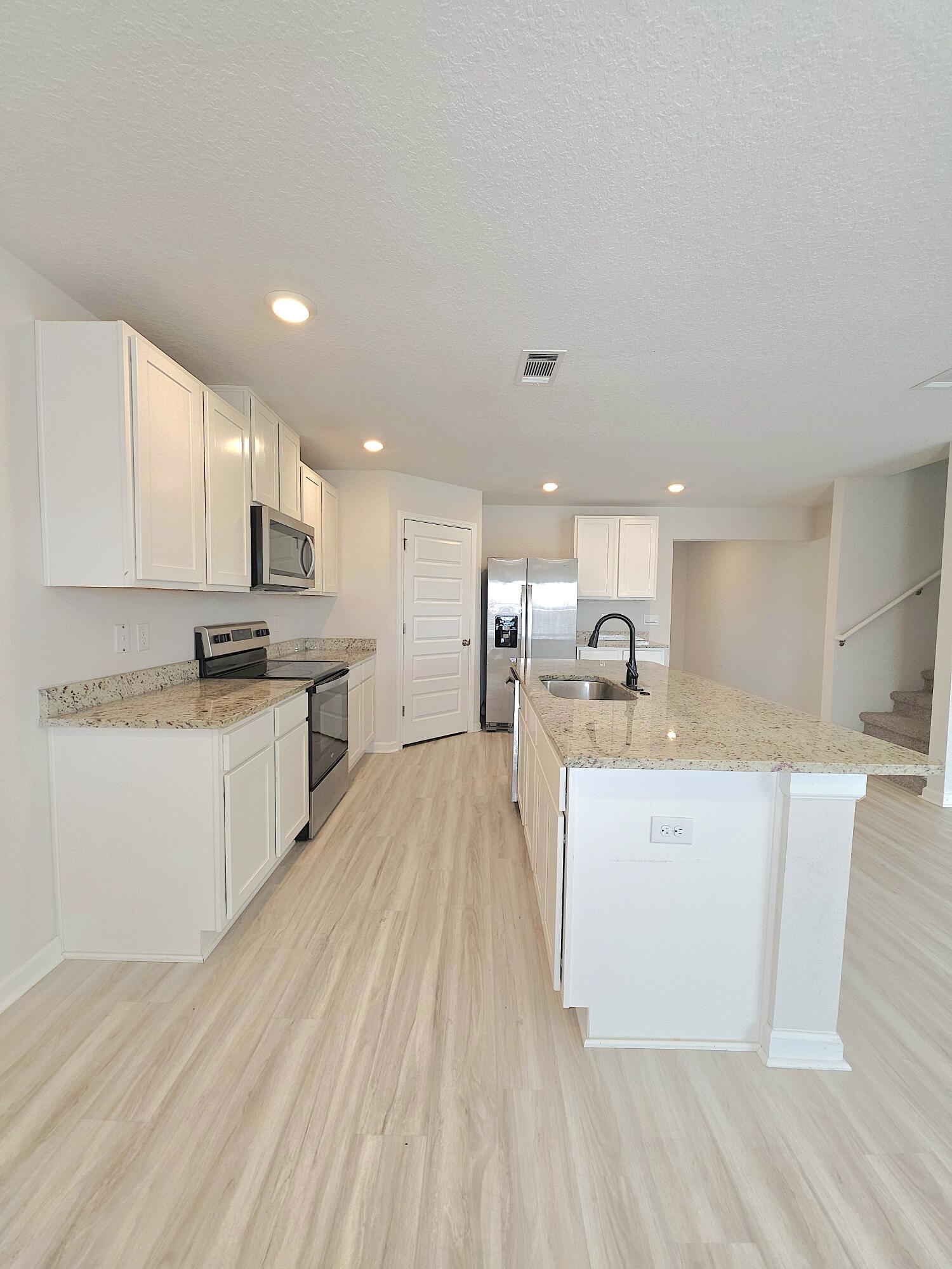 805 Otto Loop Crestview, FL 32539 - Photo 11 of 32 a view of kitchen with wooden floor