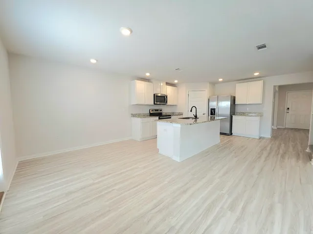 a view of kitchen with wooden floor