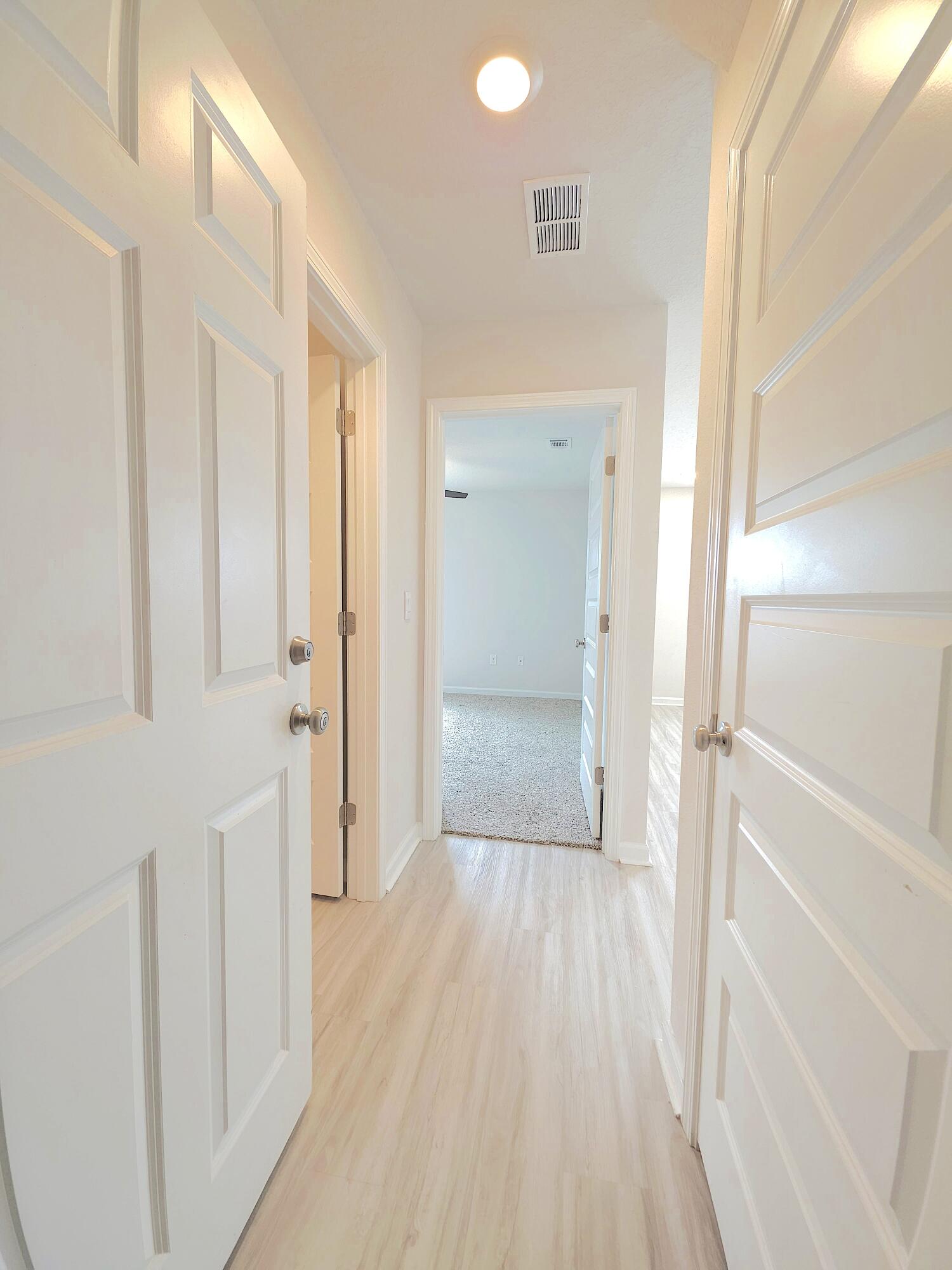 805 Otto Loop Crestview, FL 32539 - Photo 18 of 32 a view of a hallway with wooden floor and closet area