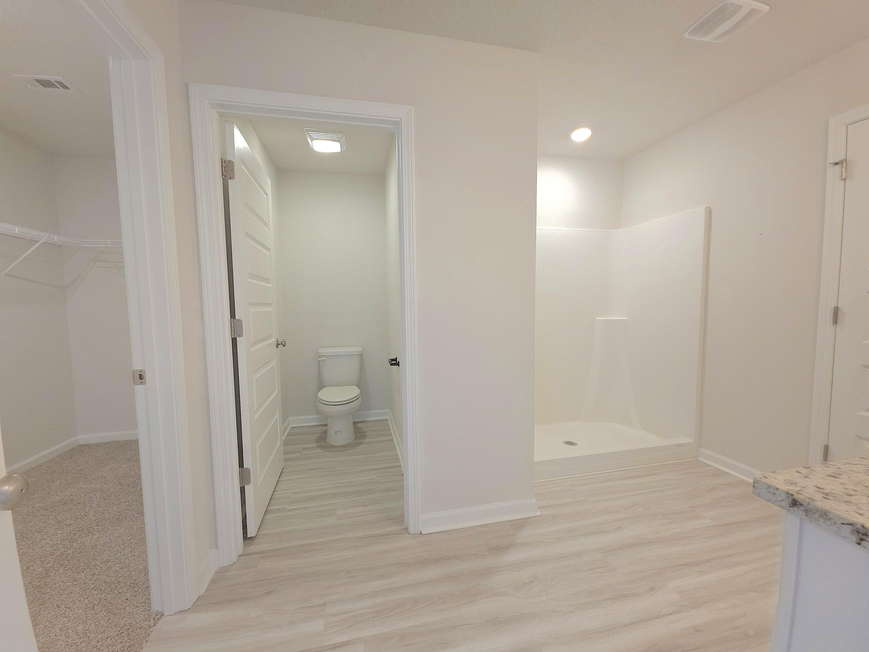 805 Otto Loop Crestview, FL 32539 - Photo 23 of 32 a view of bathroom with a toilet a sink and a shower