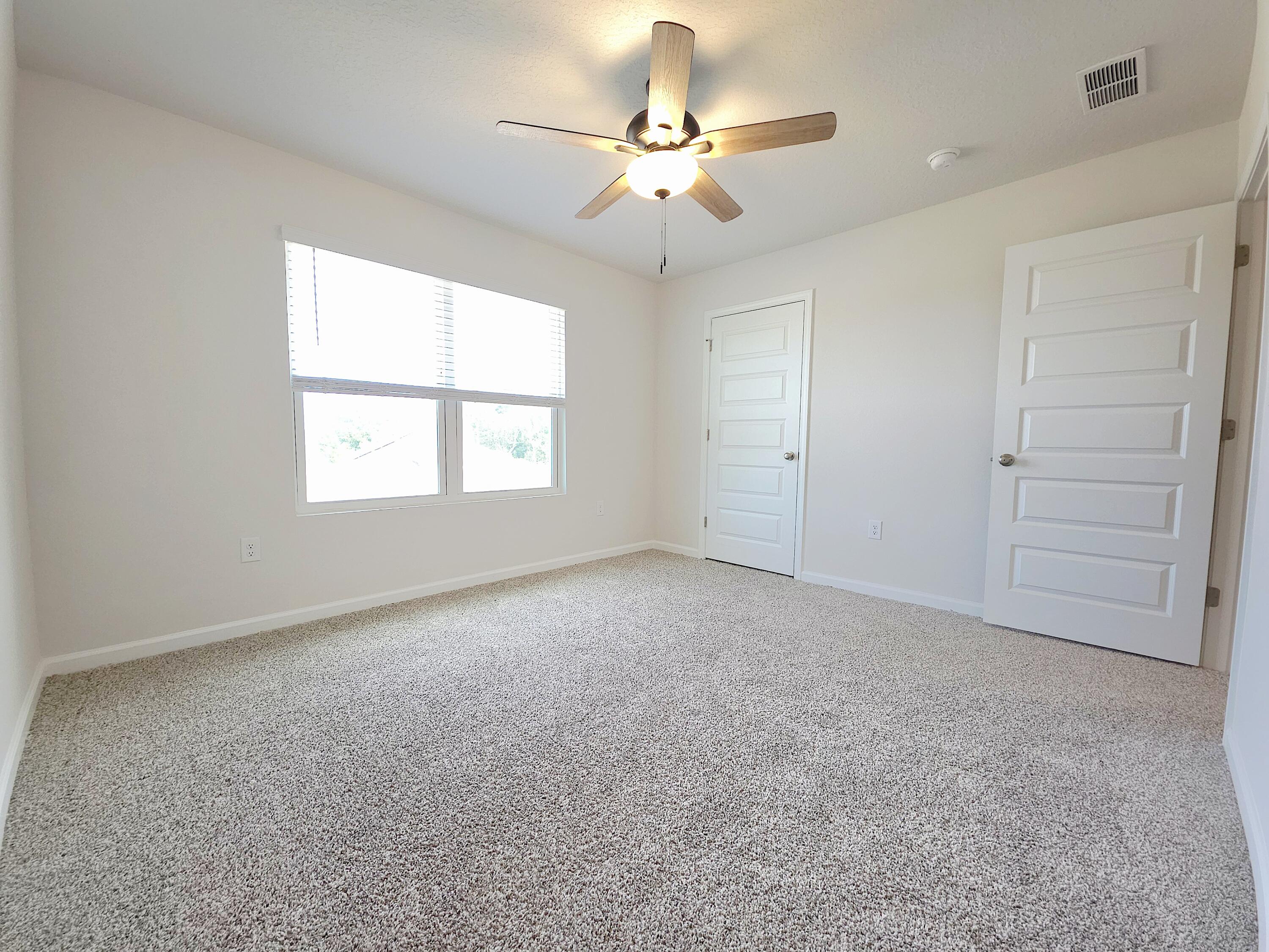 805 Otto Loop Crestview, FL 32539 - Photo 27 of 32 an empty room with windows and fan