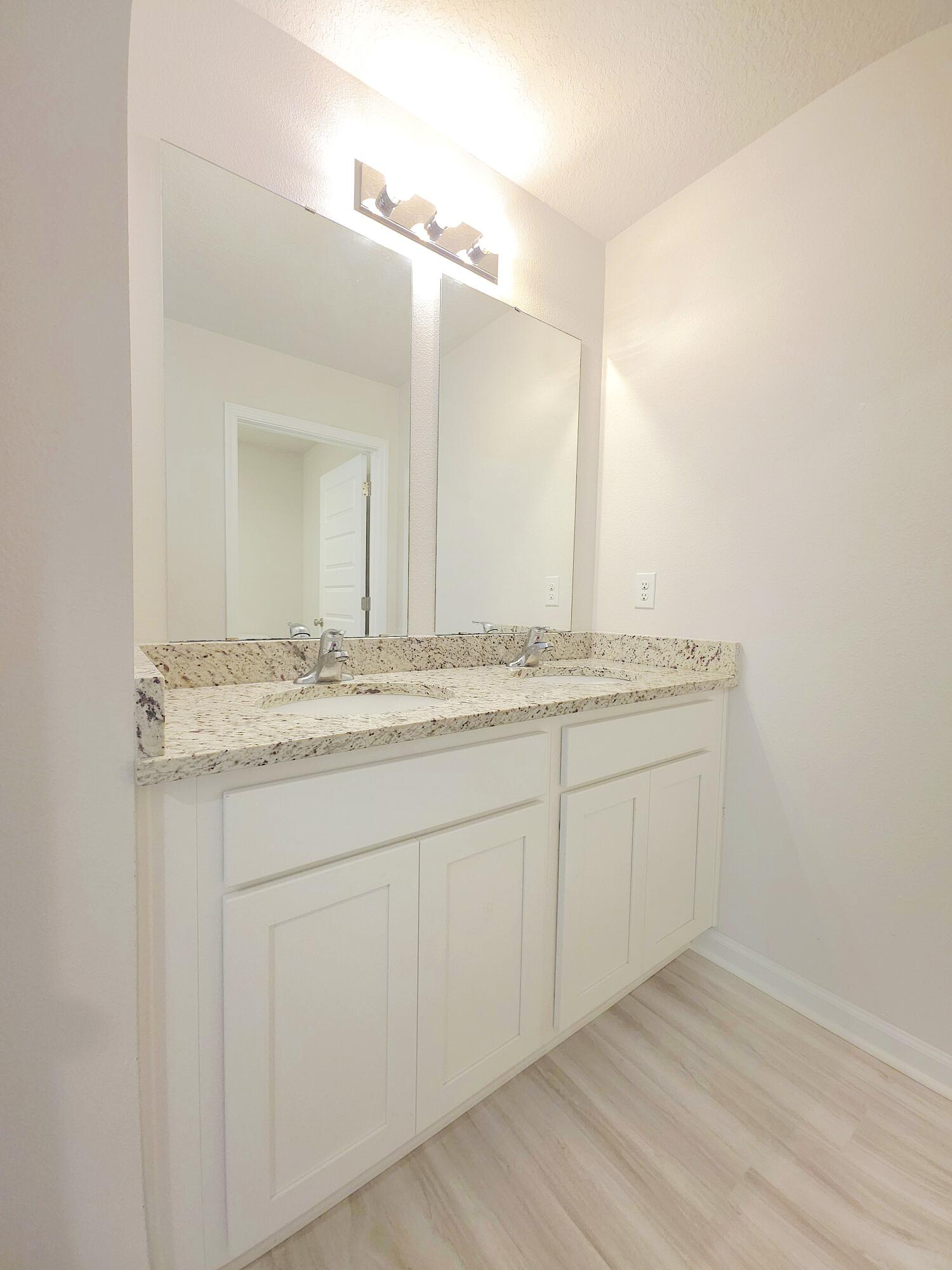 805 Otto Loop Crestview, FL 32539 - Photo 29 of 32 a bathroom with a granite countertop sink and a mirror
