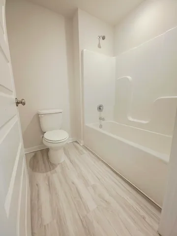 a bathroom with a toilet a sink and a bathtub