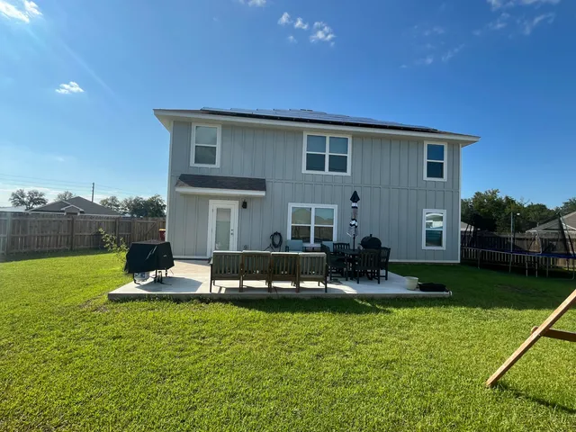 a front view of house with yard and outdoor seating