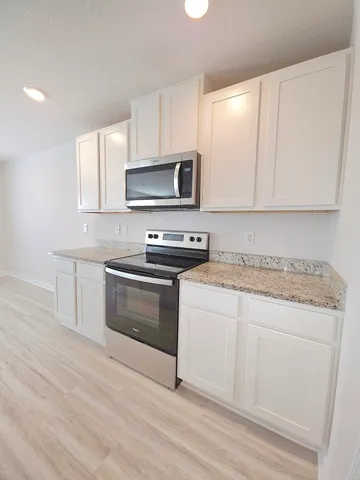 a kitchen with a stove microwave and sink