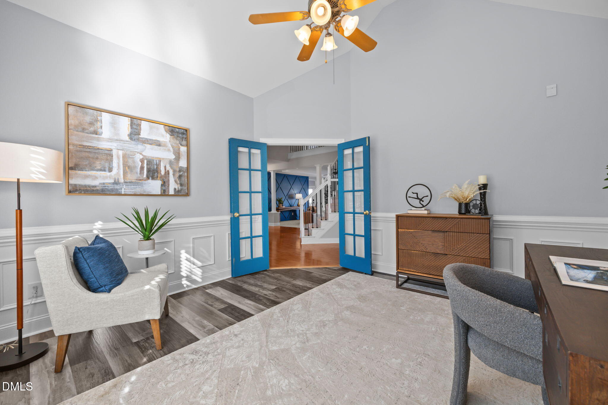 450 Seastone Street Raleigh, NC 27603 - Photo 12 of 47 a bedroom with a large bed a couch and a chandelier