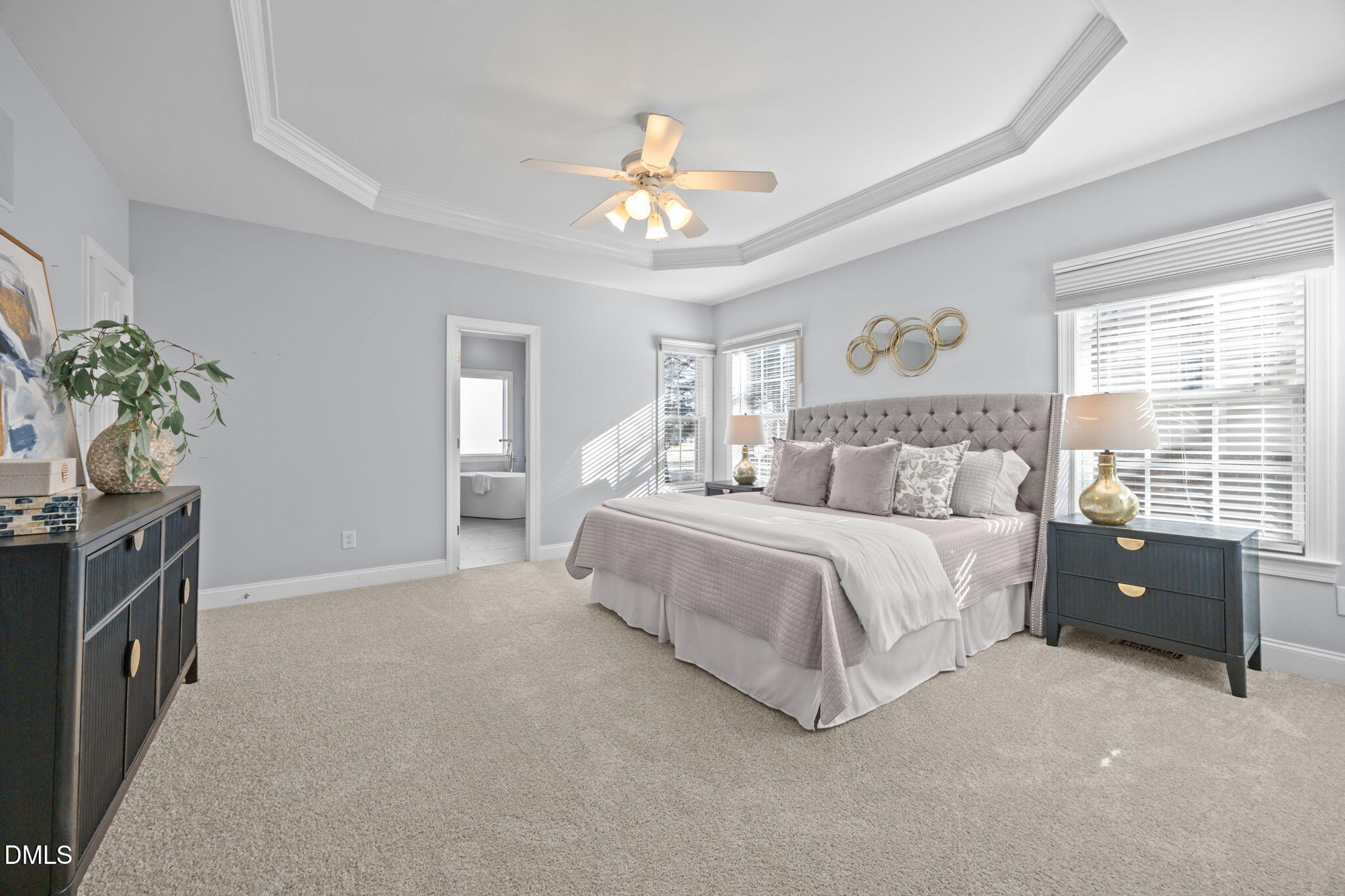 450 Seastone Street Raleigh, NC 27603 - Photo 13 of 47 a spacious bedroom with a bed and a chandelier