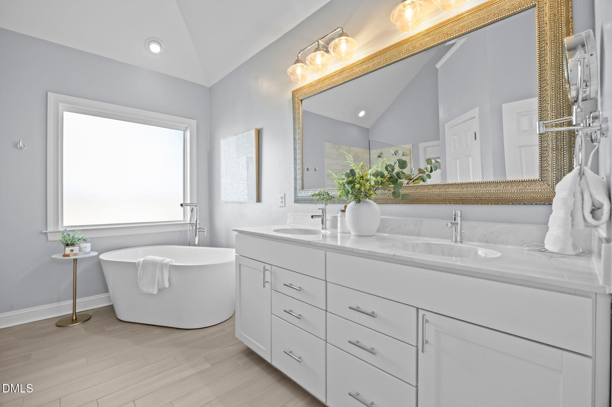 450 Seastone Street Raleigh, NC 27603 - Photo 15 of 47 a bathroom with a double vanity sink mirror and bathtub