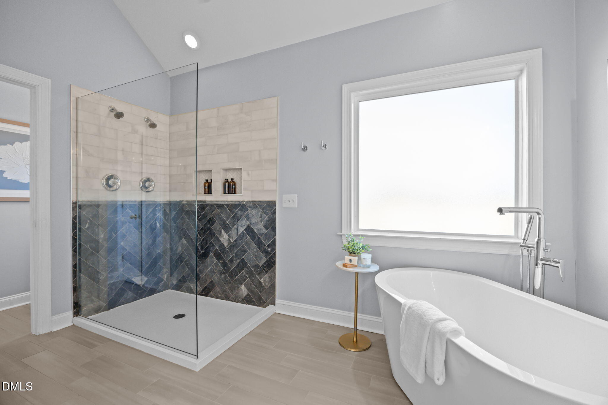 450 Seastone Street Raleigh, NC 27603 - Photo 16 of 47 a bathroom with a tub a shower and a sink