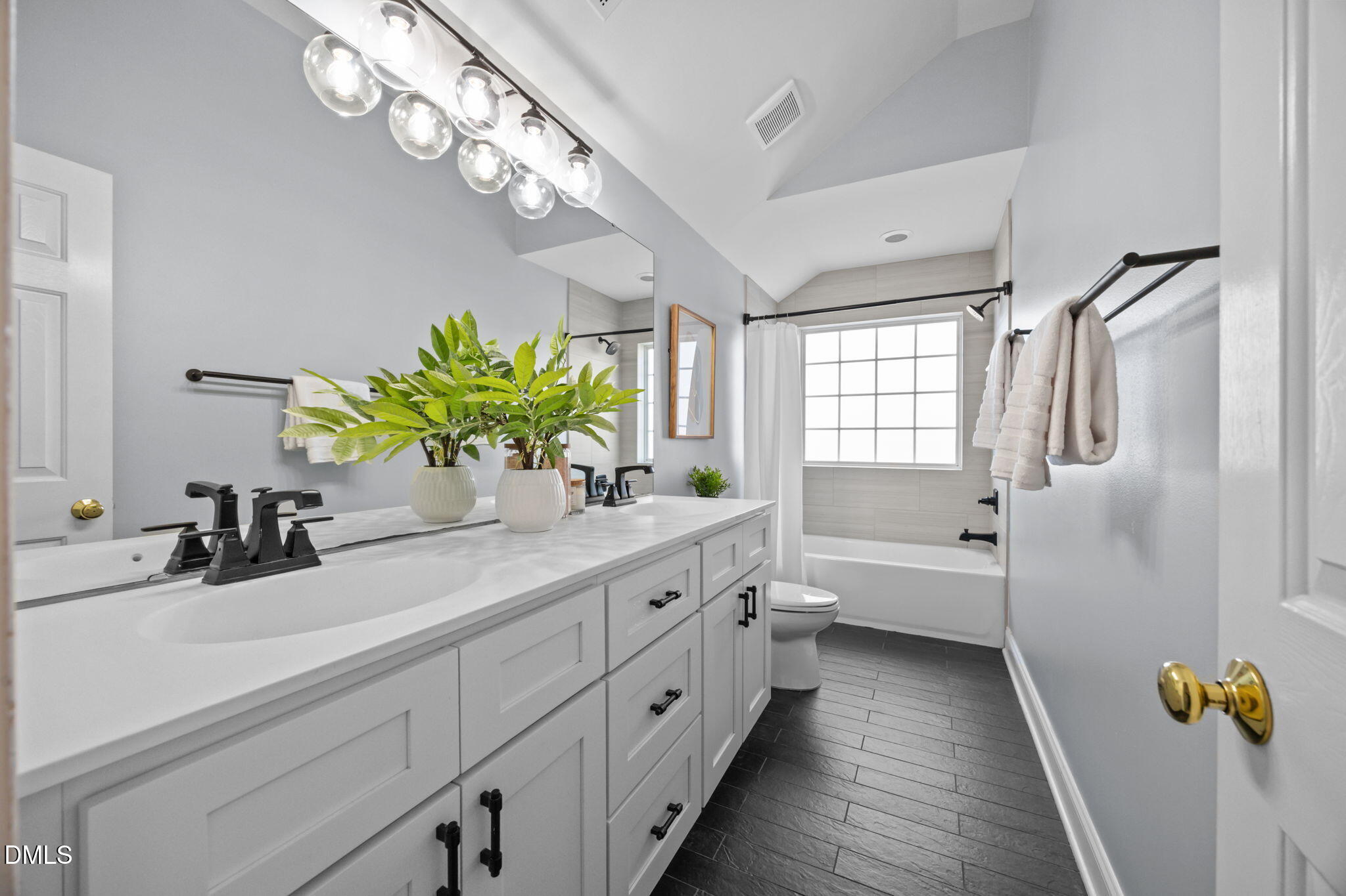 450 Seastone Street Raleigh, NC 27603 - Photo 20 of 47 a bathroom with a double vanity sink and a bathtub