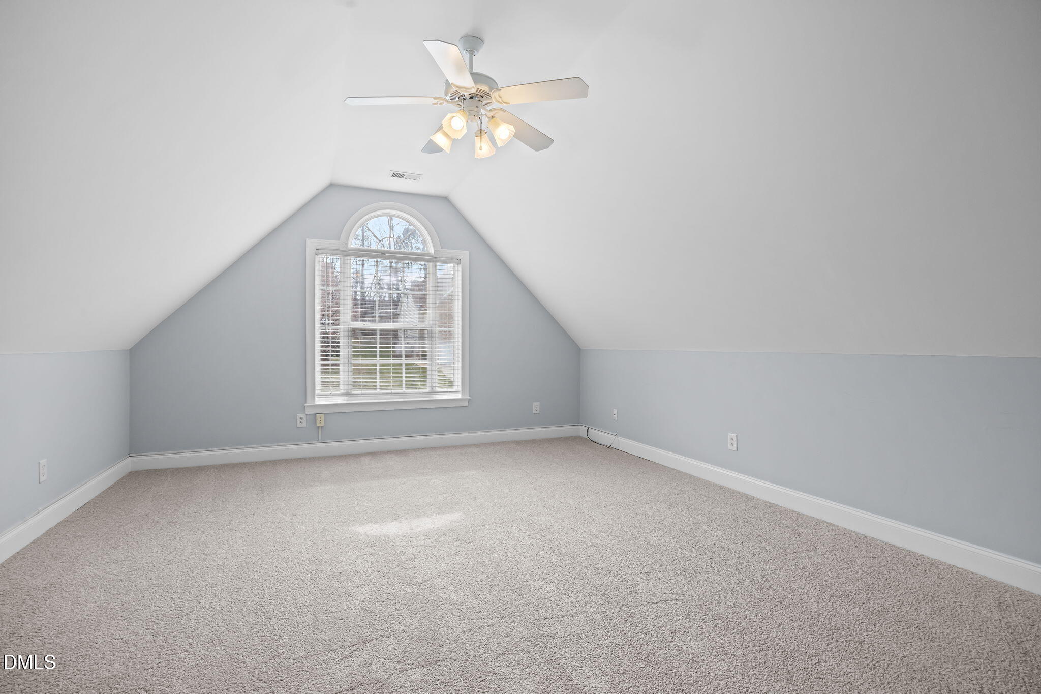 450 Seastone Street Raleigh, NC 27603 - Photo 23 of 47 an empty room with a chandelier fan and windows