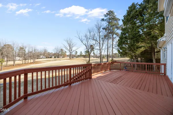 a view of balcony with wooden floor and fence