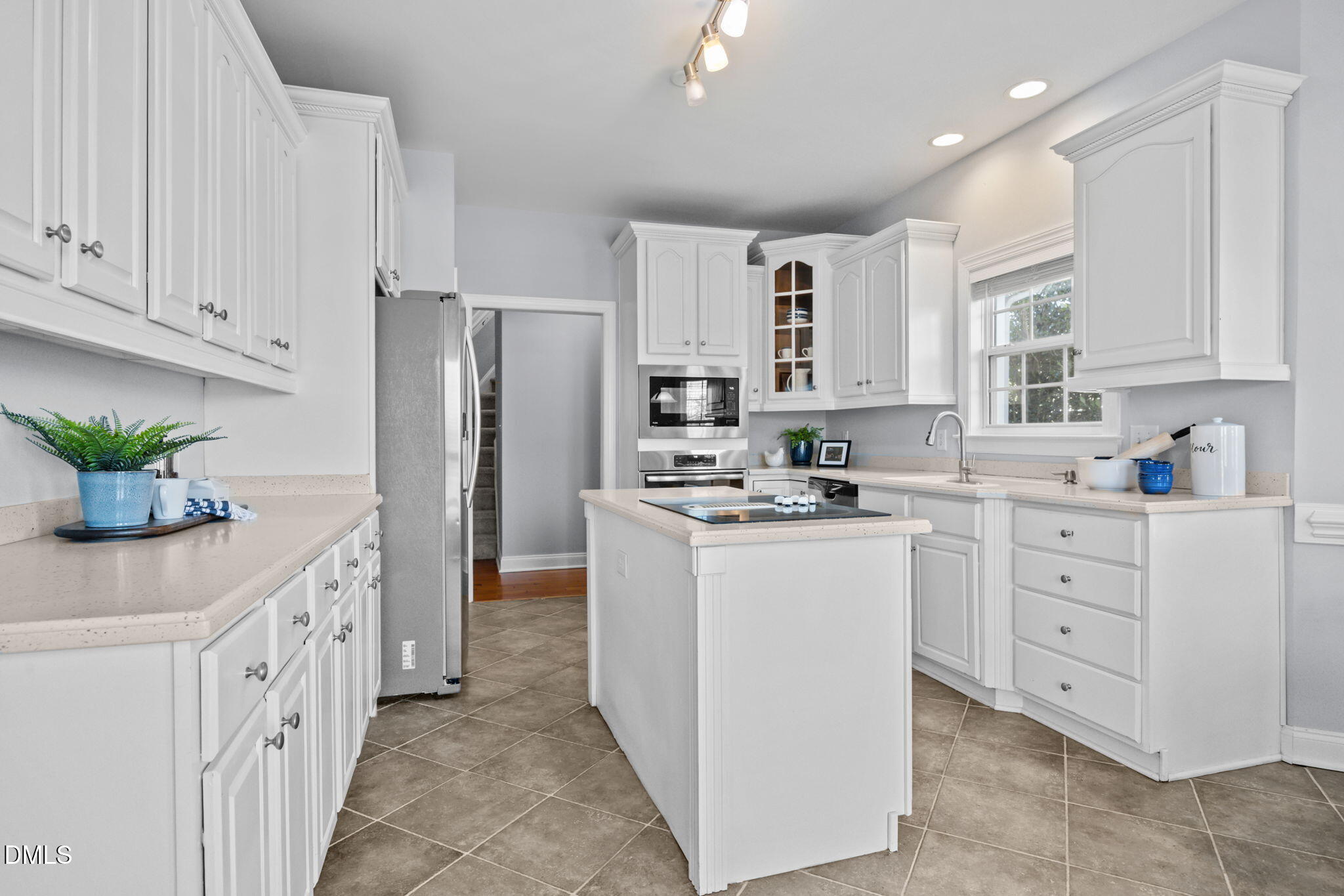450 Seastone Street Raleigh, NC 27603 - Photo 5 of 47 a kitchen with white cabinets and stainless steel appliances