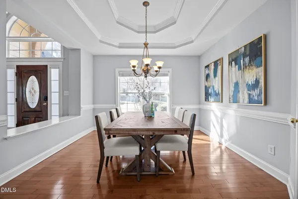 a dining room with furniture a window and a chandelier