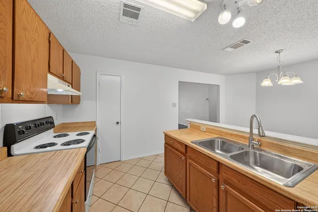 a kitchen that has a sink and a stove