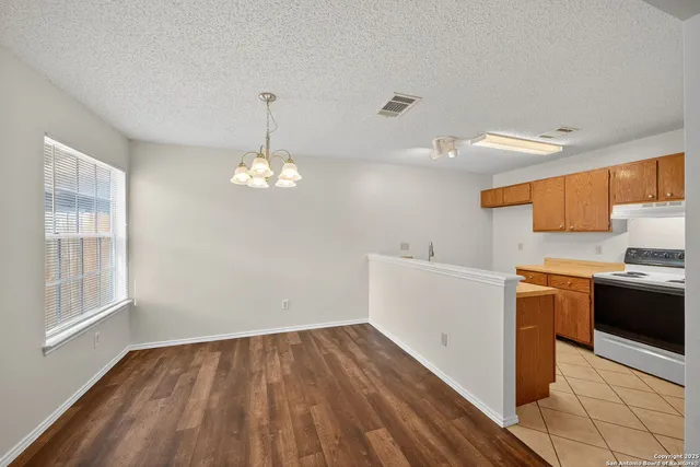 a view of a kitchen with a sink wooden floor and a window
