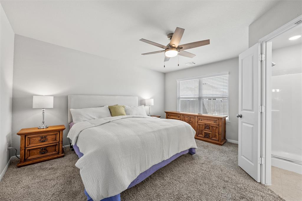 4056 Centerfire Road Waco, TX 76705 - Photo 13 of 27 a bedroom with a bed and a chandelier