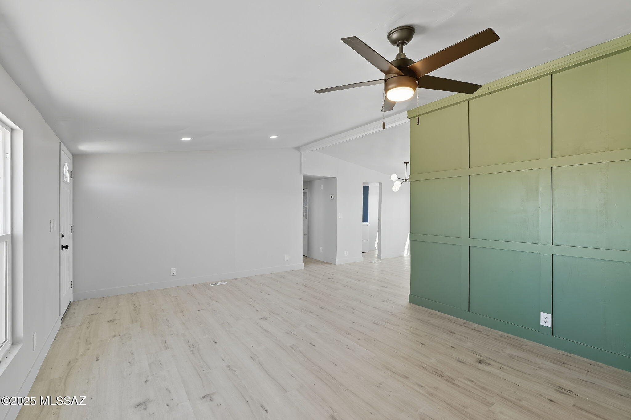 8790 North Trico Road Marana, AZ 85653 - Photo 5 of 35 a view of a livingroom with a ceiling fan and wooden floor