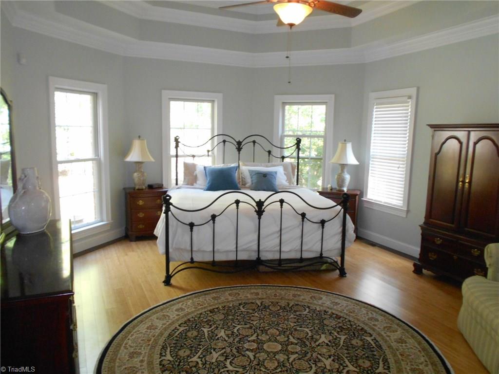 5044 Bennington Way High Point, NC 27262 - Photo 13 of 28 Master bedroom with layered tray ceiling on main level with luxurious bath & large walk-in closet.