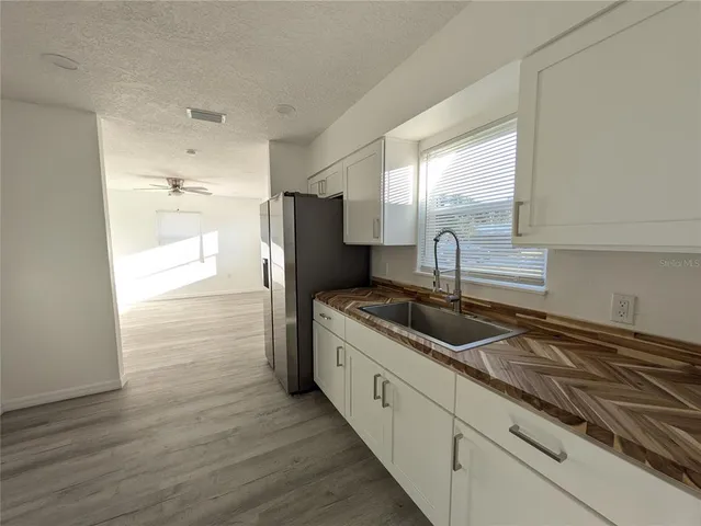 a kitchen with stainless steel appliances granite countertop a sink and a stove