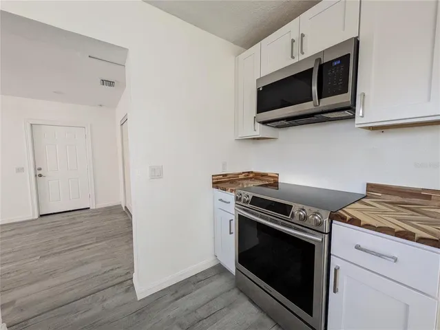 a kitchen with a stove and a microwave