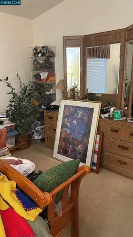 a living room with a bed and a mirror