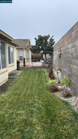 view of a house with a small yard