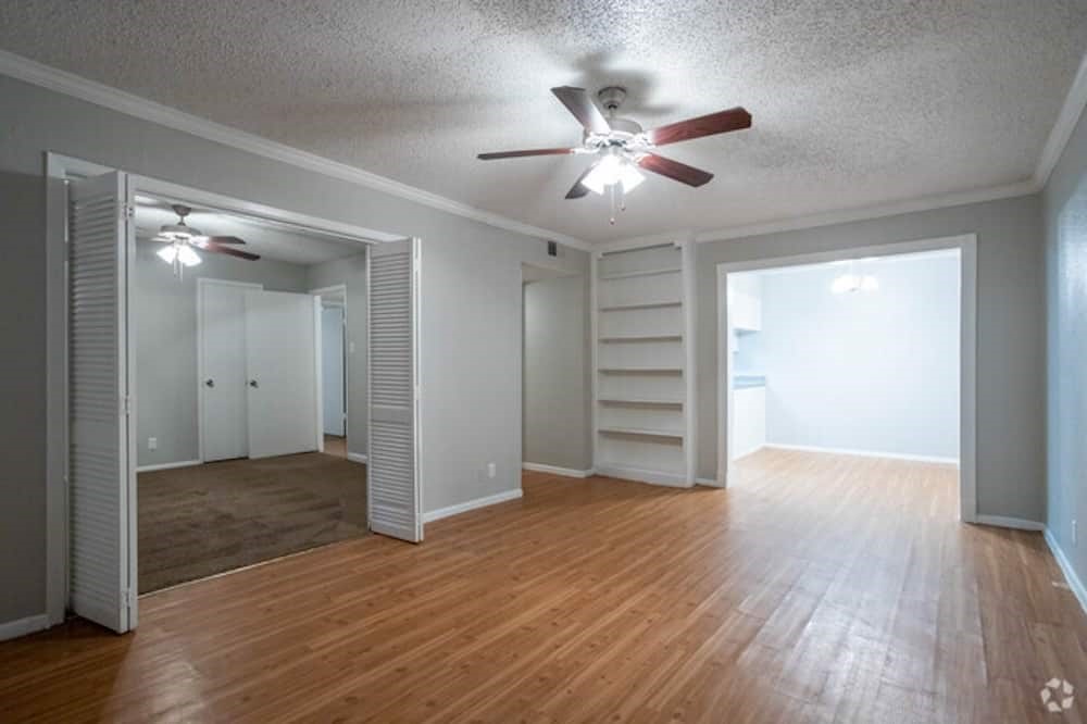 6505 Westheimer Road, Unit 246 Houston, TX 77057 - Photo 2 of 16 a view of empty room with wooden floor and fan