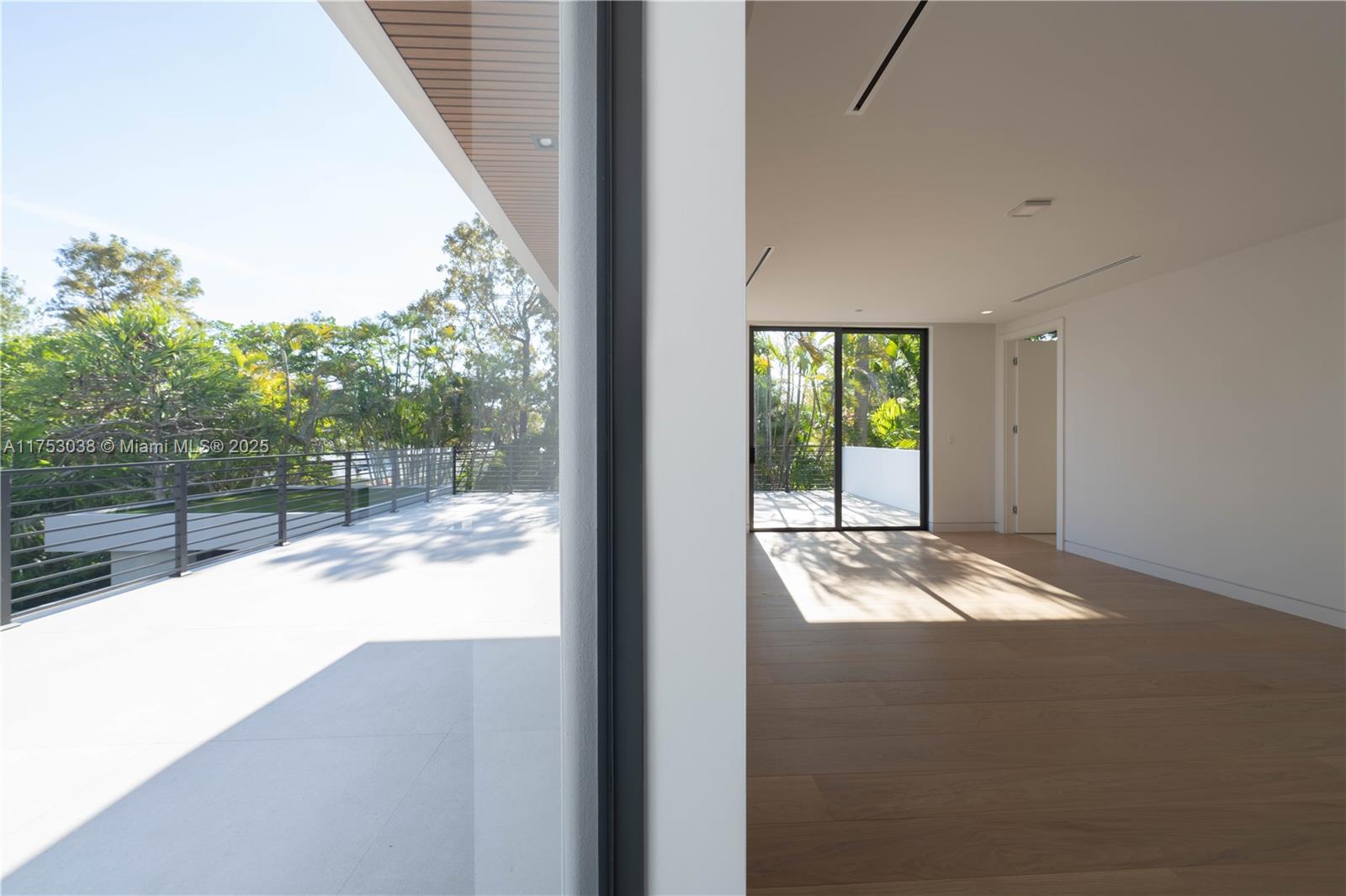 215 Shore Drive South Miami, FL 33133 - Photo 13 of 26 a view of backyard and floor to ceiling window