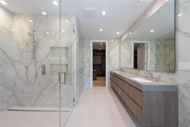 a bathroom with a double vanity sink and a shower