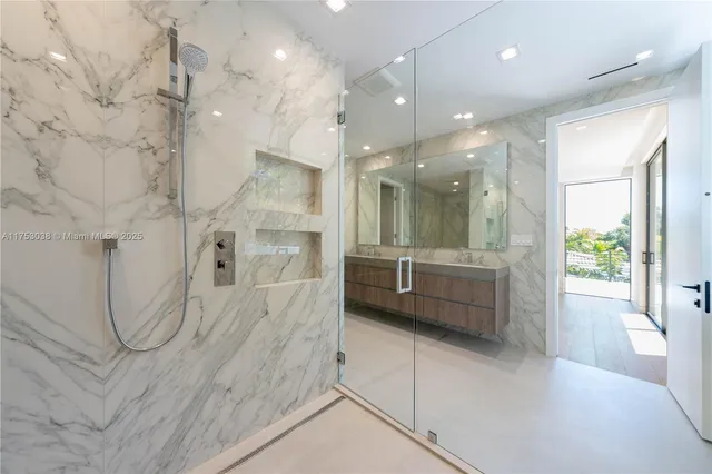 a bathroom with a double vanity sink a large mirror and shower