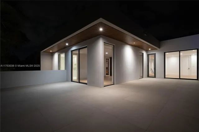 a view of an empty room with window and fireplace