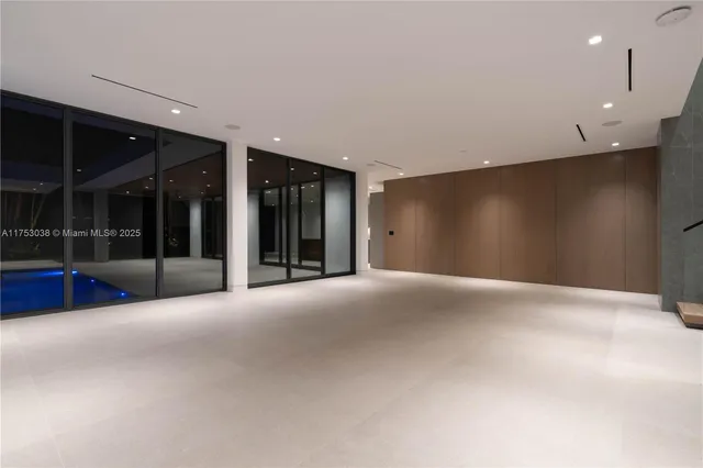 a view of an empty room with glass door