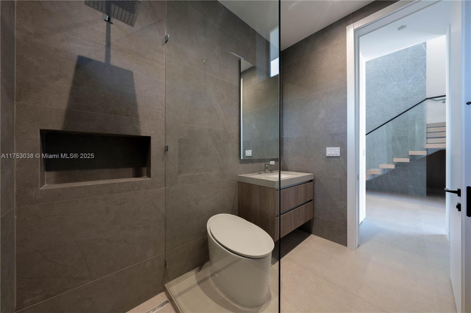 215 Shore Drive South Miami, FL 33133 - Photo 9 of 26 a bathroom with a toilet a sink and mirror