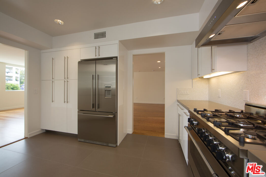 10366 Wilshire Boulevard, Unit 201 Los Angeles, CA 90024 - Photo 4 of 7 a kitchen with stainless steel appliances granite countertop a refrigerator and a stove