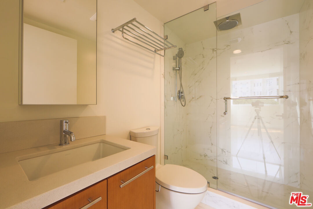 10366 Wilshire Boulevard, Unit 201 Los Angeles, CA 90024 - Photo 5 of 7 a bathroom with a sink a toilet and shower