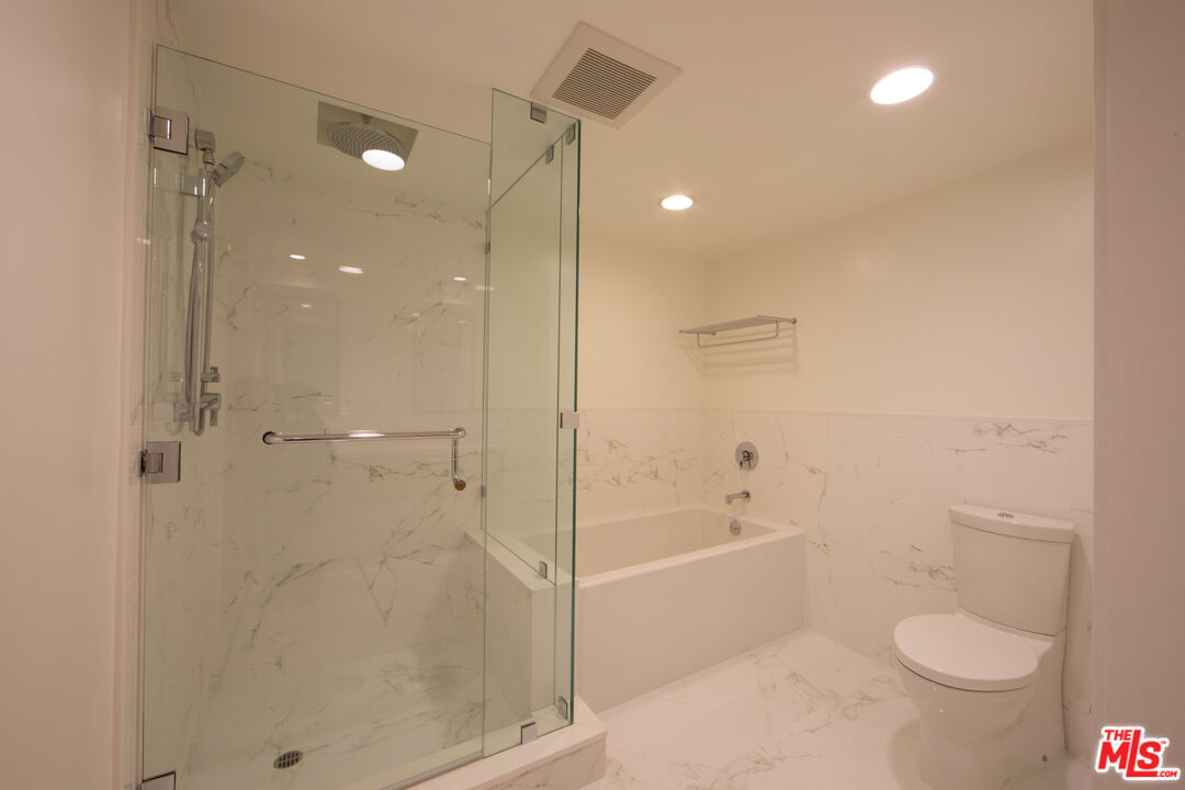 10366 Wilshire Boulevard, Unit 201 Los Angeles, CA 90024 - Photo 6 of 7 a bathroom with a shower a toilet and a shower