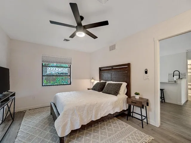 a bedroom with a bed and a flat screen tv