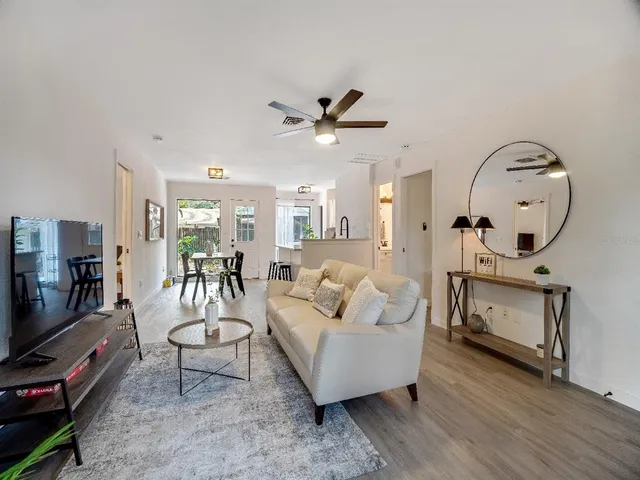 a living room with furniture a flat screen tv and a fireplace
