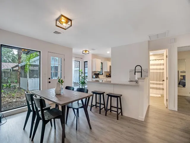 a view of a dining room with furniture and a window