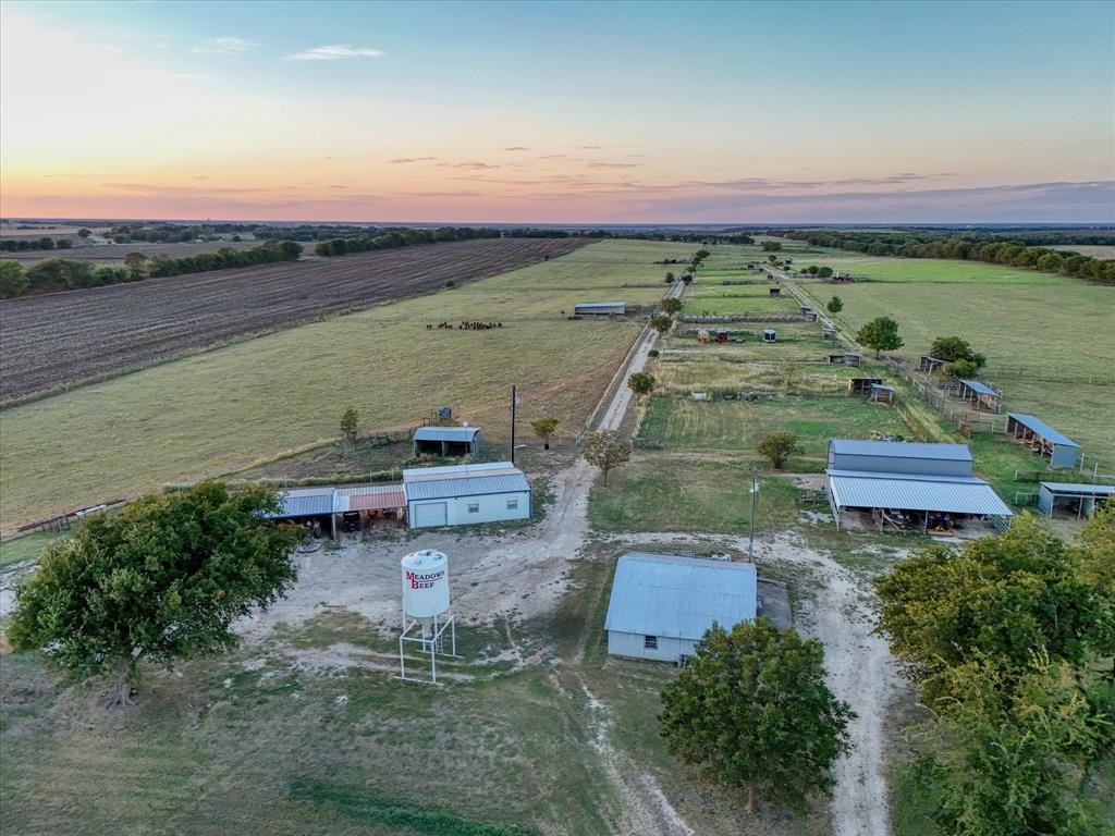 6630 Spring Valley Road Lorena, TX 76655 - Photo 5 of 23 an aerial view of a house with a garden and lake view