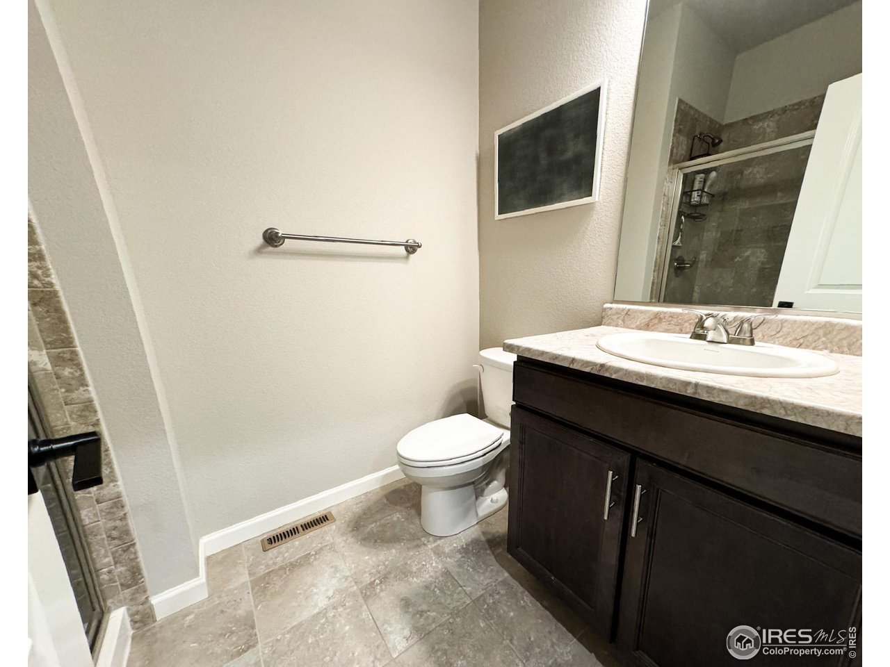 531 Ranchhand Drive Berthoud, CO 80513 - Photo 11 of 34 a bathroom with a sink a toilet a mirror and shower