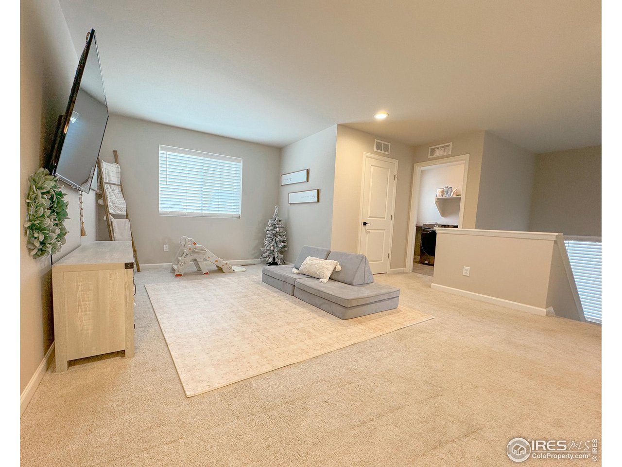 531 Ranchhand Drive Berthoud, CO 80513 - Photo 12 of 34 a spacious bedroom with a bed and a large mirror