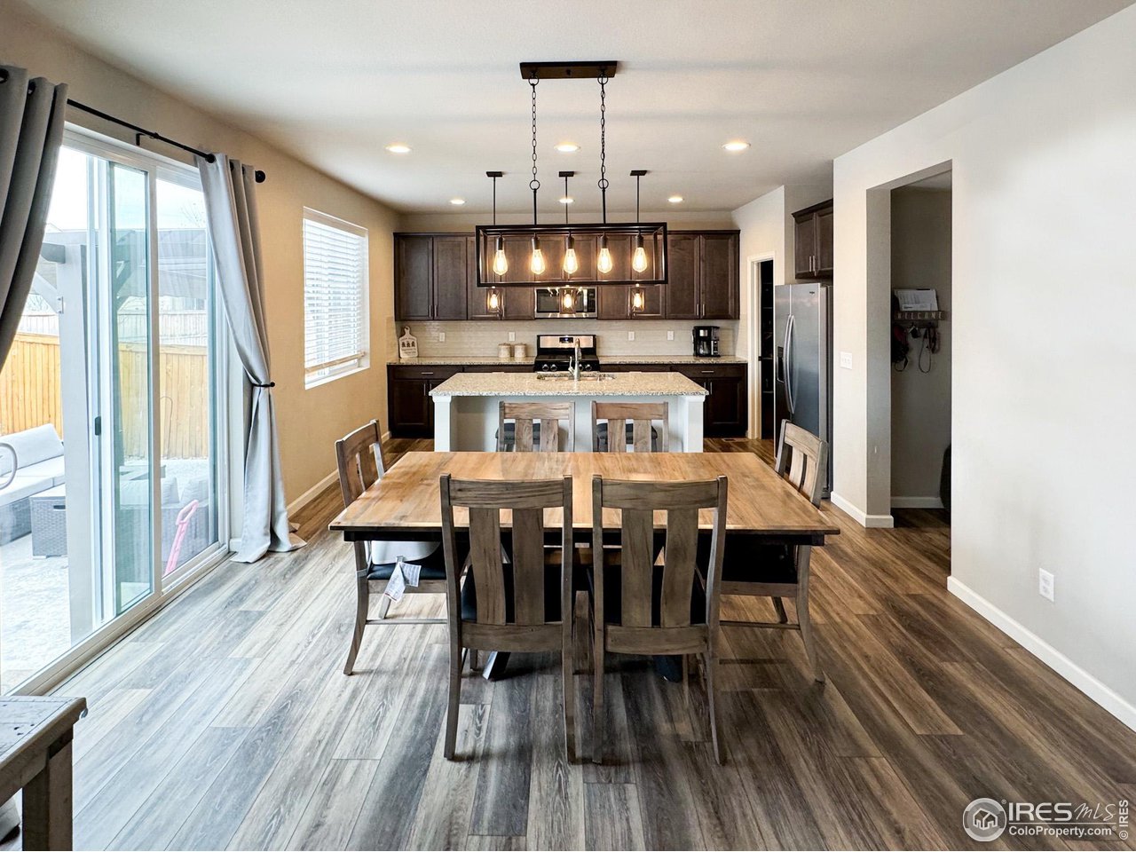 531 Ranchhand Drive Berthoud, CO 80513 - Photo 6 of 34 a view of a dining room with furniture window and wooden floor